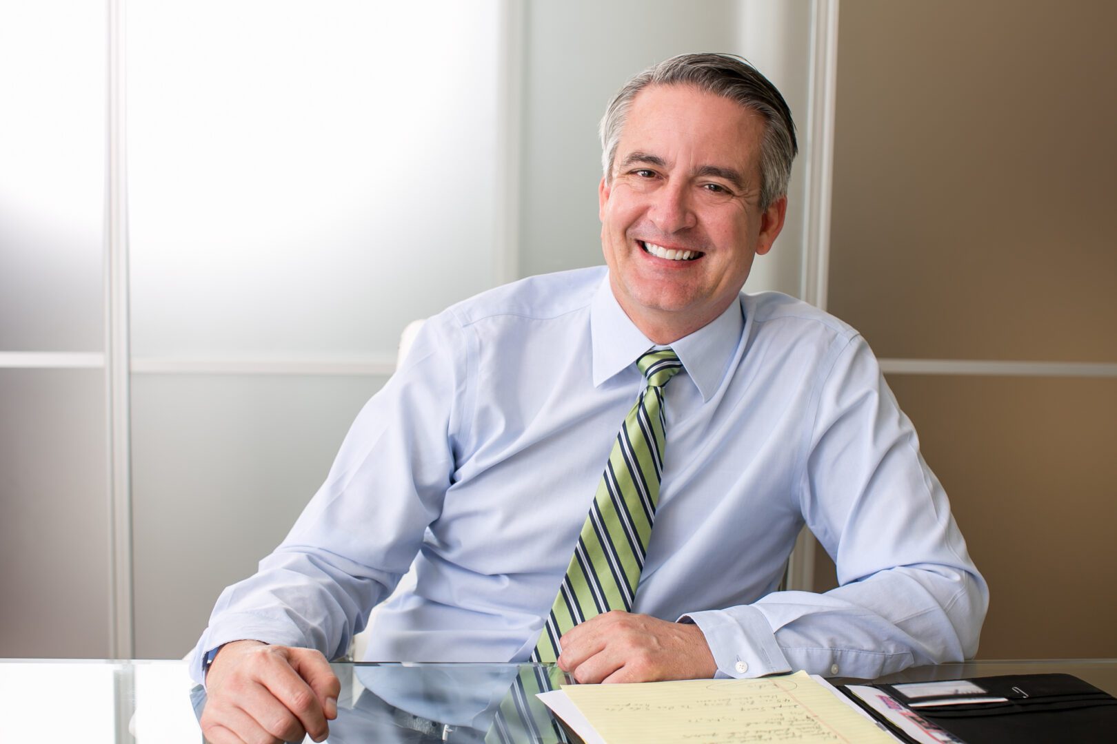 Mature happy smiling business man at his desk