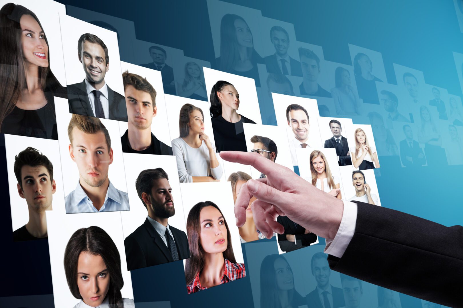 Businessman hand going through candidate picture gallery on blue background. Social media and recruiting concept
